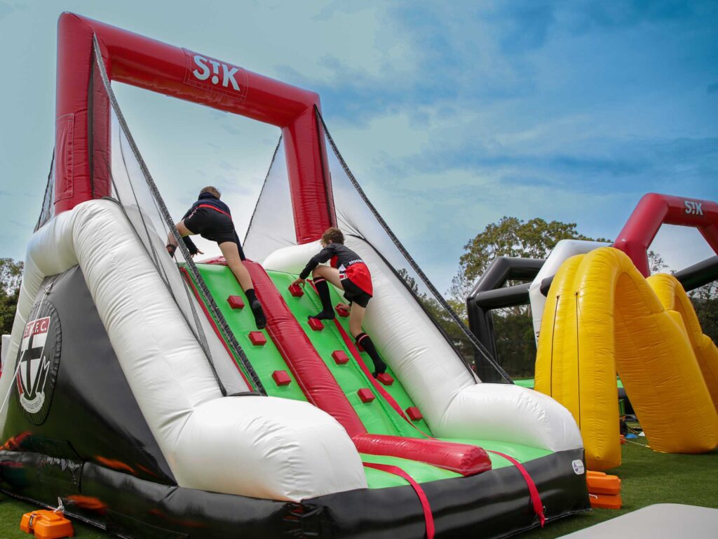 Inflatable AFL climb and slides are a perfect activity for young athletes while providing a bold brand activation opportunity for sponsors.